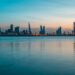 Manama city skyscraper view from body of water.